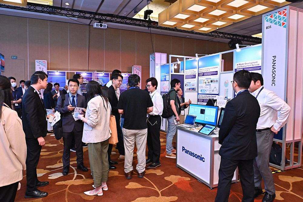 Photograph of people networking at an exhibition booth